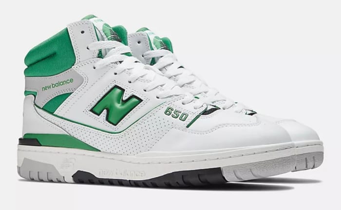 View of white and green New Balance shoes.